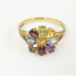 A 9ct gold ring set with various coloured stones in a floral setting. Ring size approx. P Please