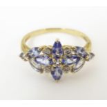 A 9ct gold ring set with tanzanite coloured stone and diamonds. Ring size approx. P Please Note - we