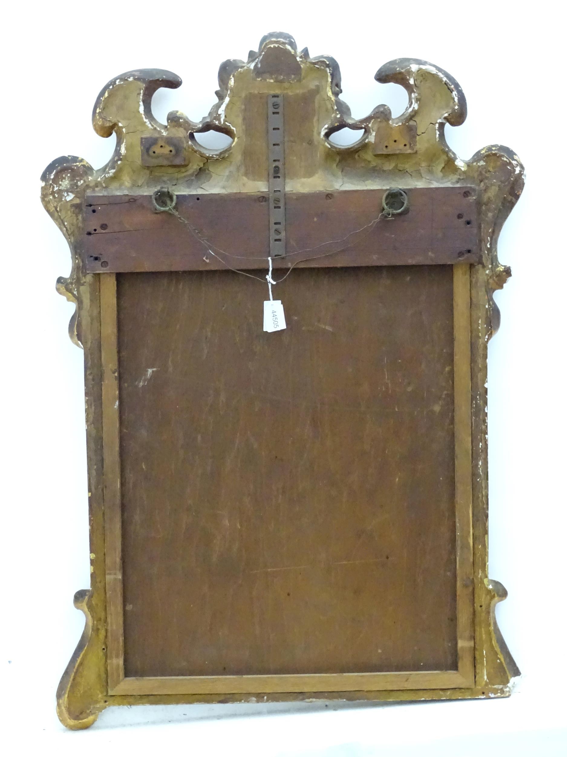 A 19thC gilt mirror with a moulded anthemion to the top and floral decorations to the frame. 23" - Image 3 of 3