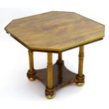 A Regency rosewood centre table, having an octagonal top with a brass trim to its edge, having