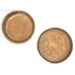 A copper dish of circular form with punchwork and hammered detail. Together with another. Largest