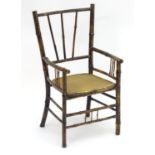 A late 19thC Aesthetic movement child's chair with a turned bamboo frame. 13 1/2" wide x 11" deep