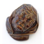 A Bretby treacle glaze wall pocket modelled as a male head. Marked under, pattern number 887.