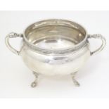 A silver twin handled porringer / bowl with Celtic style banded detail, with the handles and