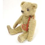 Toys: A 20thC teddy bear with stitched nose and paws, articulated limbs and head. Approximately 13