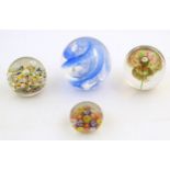 Four assorted glass paperweights. The largest approx 3 1/2" high Please Note - we do not make