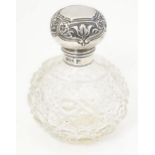 A cut glass perfume / scent bottle with silver lid and mount hallmarked Sheffield 1911, maker Walker