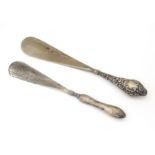 Two silver handled shoe horns, one hallmarked Chester 1906, the other Birmingham 1912. 9 3/4"