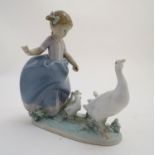 A Lladro figure of a girl with ducks, Hurry Now, model no. 5503. Marked under. Approx. 7" high.