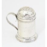 A silver pepperette formed as flour shaker, hallmarked Birmingham 1901, maker Thomas Ducrow. Approx.