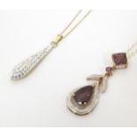 A 9ct gold necklace, the pendant set with garnet and diamonds. Approx. 20" long overall, together