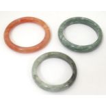 Three assorted hardstone bracelets of bangle form (3) Please Note - we do not make reference to