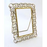 A Victorian brass easel back photograph frame with scroll detail. Approx. 12" high overall Please