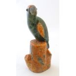 An Art Deco / Mid century soapstone model of a parrot on a branch with lucite beak and eyes. Approx.