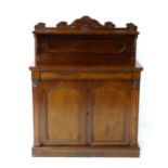 A William IV mahogany chiffonier with a carved upstand about a single long drawers above two