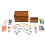An early 20thC games compendium / box, the exterior with chequered mahogany panelling, fitted