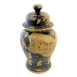 An Oriental black and ochre lidded ginger jar decorated with figures in a landscape with pagoda