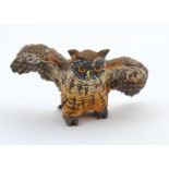 A cold painted bronze model of an owl with spread wings. Approx. 2" long Please Note - we do not