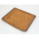 An Arts & Crafts Newlyn School copper tray of rectangular form with embossed decoration depicting