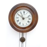 A postmans alarm style wall clock with cast black forest style pine cone weights. The movement