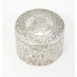 A Victorian silver pill box of circular form with engraved decoration, hallmarked London 1897, maker