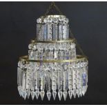 An early 20thC bag light shade, formed in three circular tiers of drop lustres in graduated