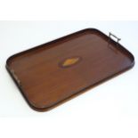 A late 19th / early 20thC mahogany tray of rectangular form with twin handles and central
