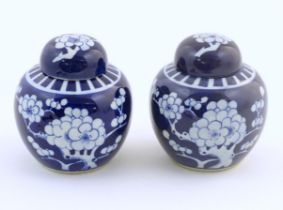 Two Chinese blue and white ginger jars with prunus blossom decoration. Approx. 6 1/4" high (2)