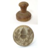 Kitchenalia: a 19thC carved wooden butter pat, the base with acorn and oak leaf decoration. Standing