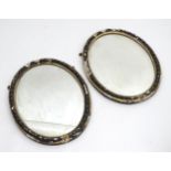 A pair of 19thC oval mirrors with gesso gilt and ebonised frames. 21" wide x 27" high. Please Note -