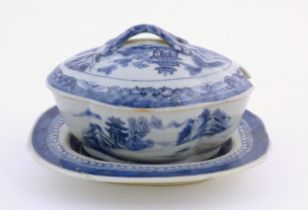 A Chinese blue and white soup tureen of quatrefoil form decorated with a landscape scene with pagoda