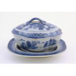 A Chinese blue and white soup tureen of quatrefoil form decorated with a landscape scene with pagoda
