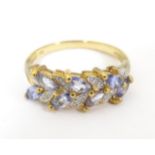 A 9ct gold ring set with diamonds and tanzanites. Ring size approx. O 1/2 Please Note - we do not