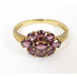 A 9ct gold ring set with amethysts. Ring size approx. P Please Note - we do not make reference to