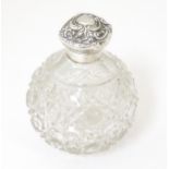 A cut glass perfume / scent bottle with silver lid and mount hallmarked Birmingham 1903, maker