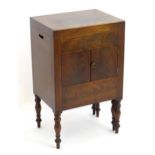 A Regency mahogany commode bedside cabinet with figured mahogany veneers, pierced handles to