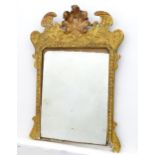 A 19thC gilt mirror with a moulded anthemion to the top and floral decorations to the frame. 23"