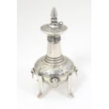 A white metal scent bottle with engraved decoration formed as a stylised pagoda building on four
