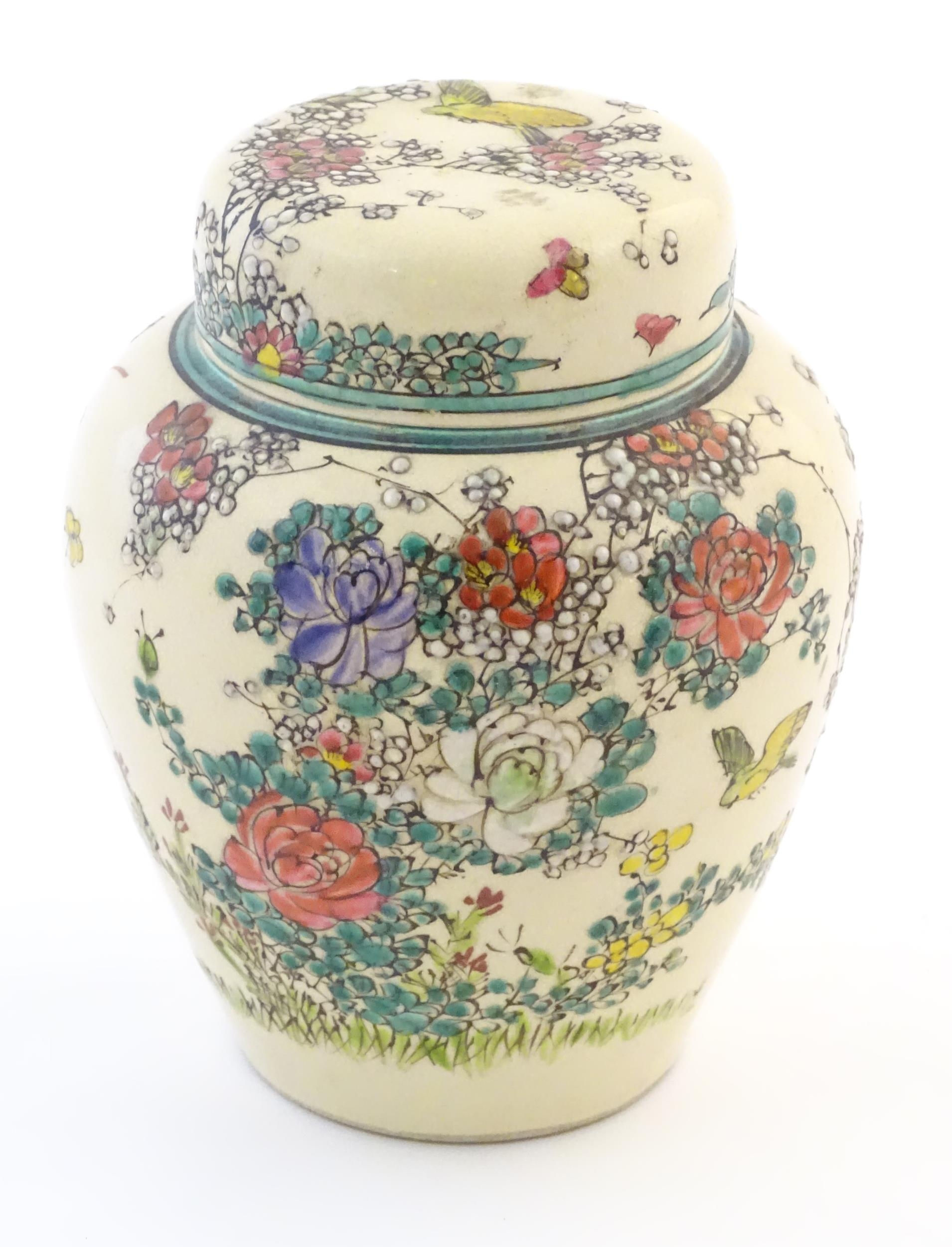 An Oriental ginger jar and cover with inner lid, decorated with flowers and foliage. Possibly