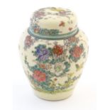 An Oriental ginger jar and cover with inner lid, decorated with flowers and foliage. Possibly