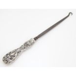 A silver handled button hook with embossed decoration, hallmarked London 1907, maker Mappin &
