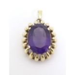 A 9ct gold pendant set with large amethyst. Approx 1 1/2" long Please Note - we do not make