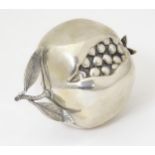 A silver miniature model of a pomegranate fruit. Approx. 3 1/2" long Please Note - we do not make