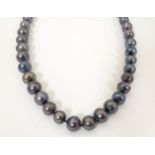 A long black pearl necklace approx. 52" long Please Note - we do not make reference to the condition