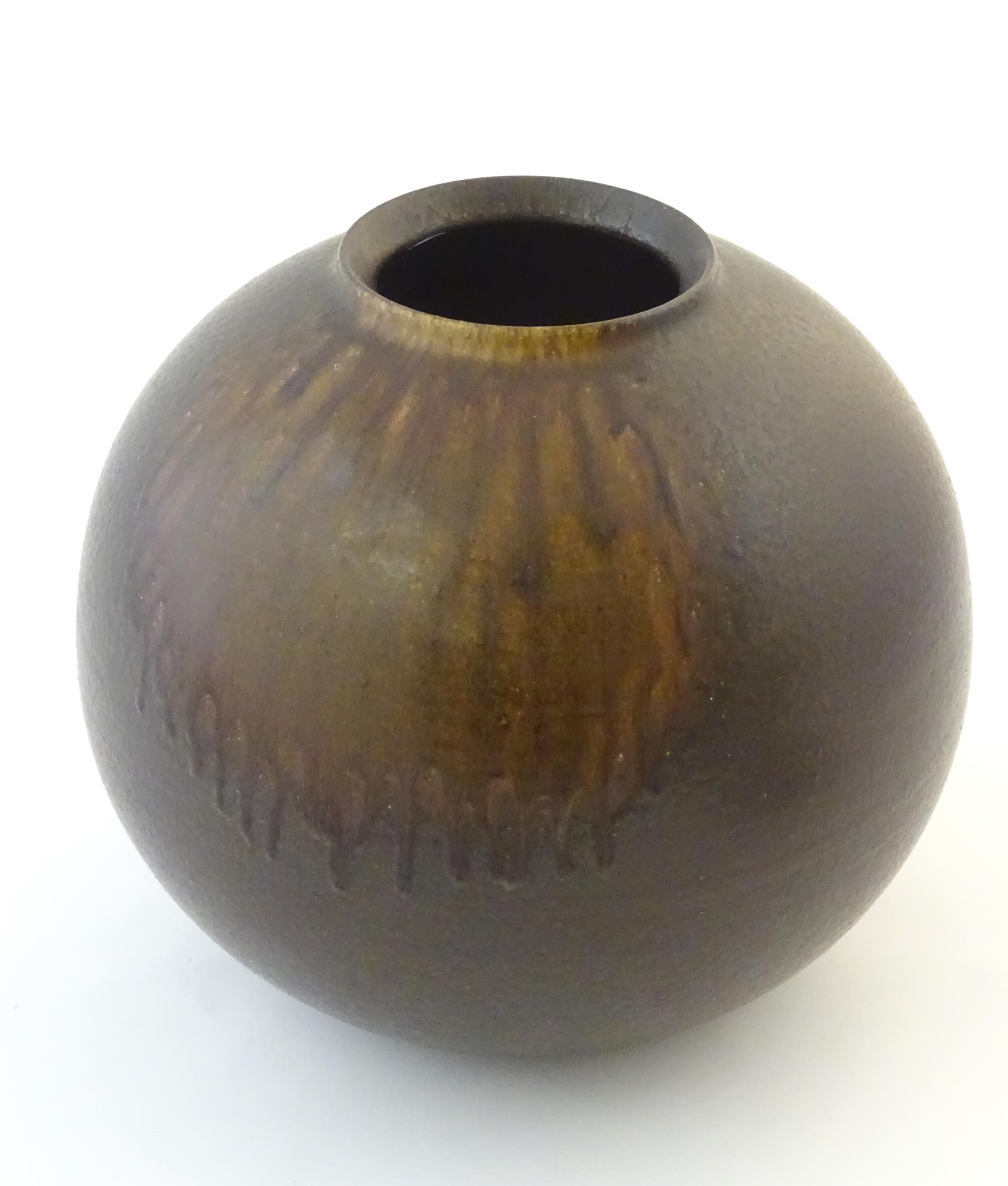 A Japanese vase of globular form with a drip glaze. Approx. 10 3/4" high Please Note - we do not