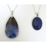 Two necklaces both set with hardstone pendants on silver chains approx. 18" long. (2) Please