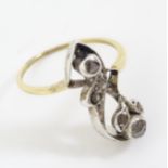 A yellow metal ring set with diamonds in a foliate setting. Ring size approx. R 1/2 Please Note - we