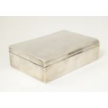 A silver cigarette box with wood lined interior. Hallmarked Birmingham 1960. 5" wide x 3 1/2"deep