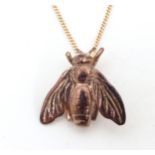 A rose gilt metal pendant in the form of a Napoleonic bee on a 9ct rose gold adjustable length