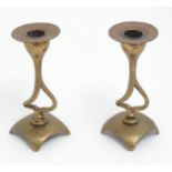 A pair of Art Nouveau brass and copper candlesticks with sinuous openwork columns. Approx. 6 1/4"